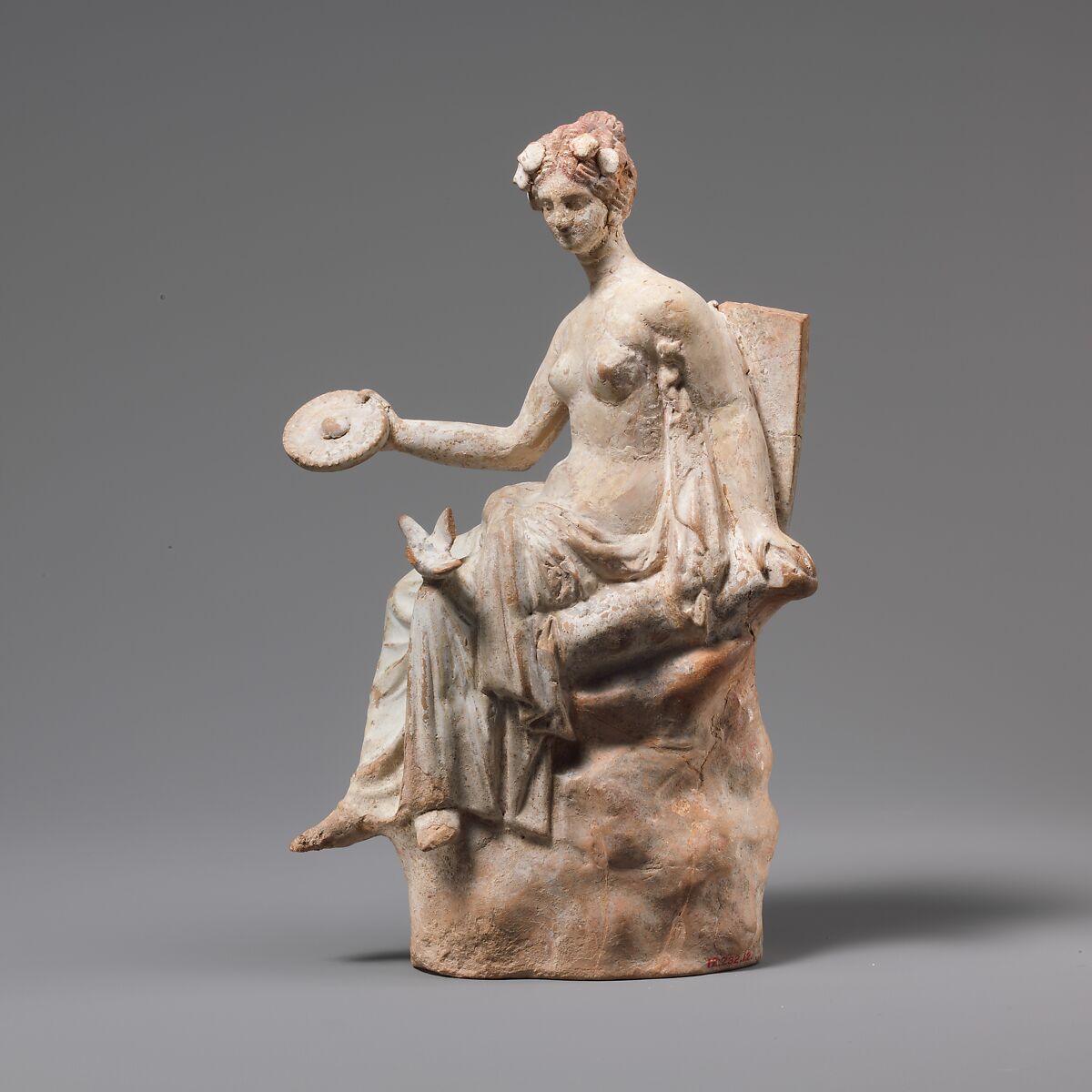 Terracotta statuette of Aphrodite seated on a rock | Greek, South Italian |  Hellenistic | The Metropolitan Museum of Art
