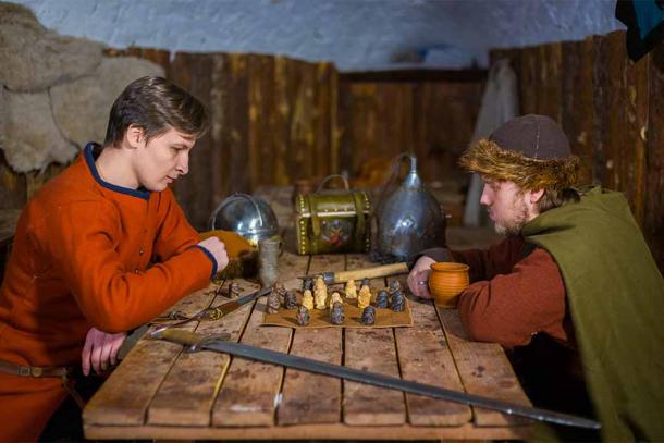 Two men in Viking costume playing Hnefatafl, also known as tafl, of which Tablut is a variation played by the Sami people of Lapland. (happy_finch / Adobe Stock)