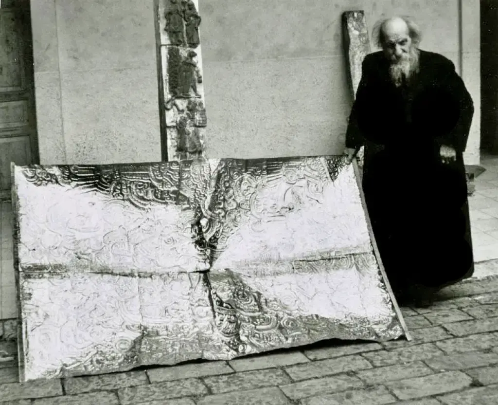 Father Carlo Crespi (1891-1982) next to a metal artifact at Maria Auxiliadora church.