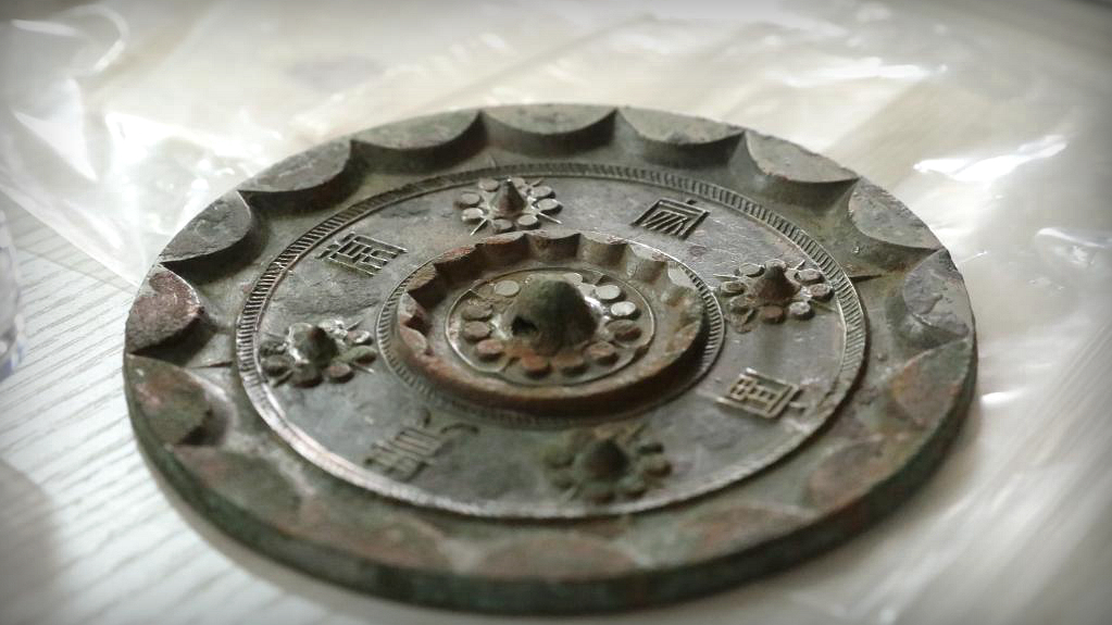 Over 2,000-year-old bronze mirrors unearthed at cemetery in NW China - CGTN