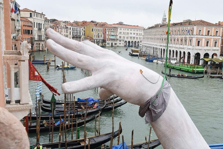 Monumental hands emerge from Venice's Grand Canal to highlight the effects  of climate change - ABC News