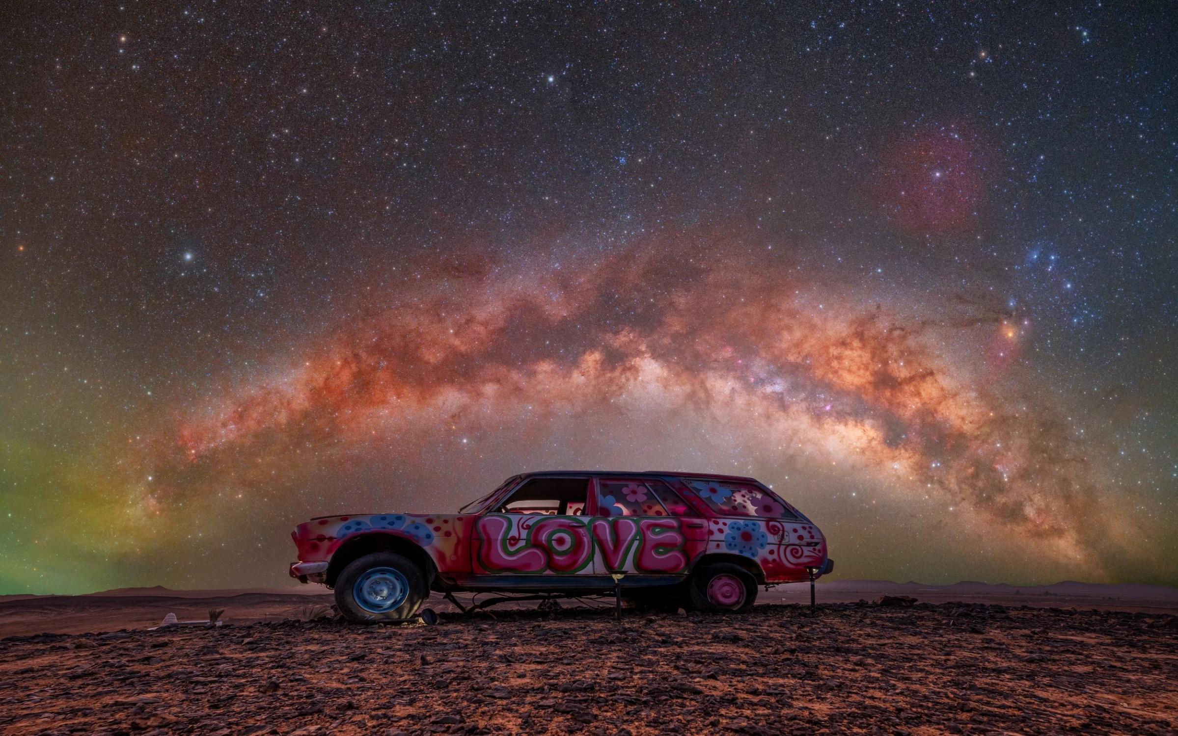 The Milky Way gracefully stretches across the vast expanse of Egypt's Black Desert, illuminating the ancient sands with celestial wonder.