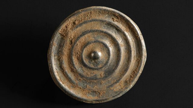 A finely crafted bronze button, a tiny yet fascinating relic from the Peebles Hoard.