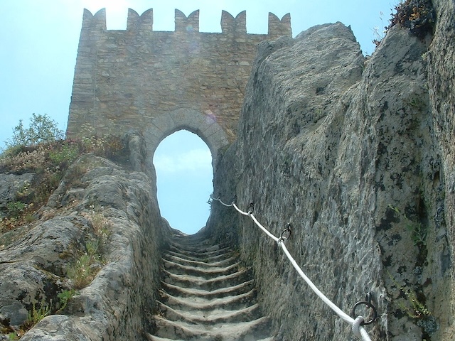 Climb the rugged stone steps of Sperlinga Castle, where the remnants of medieval architecture are carved into the very rock of the mountain