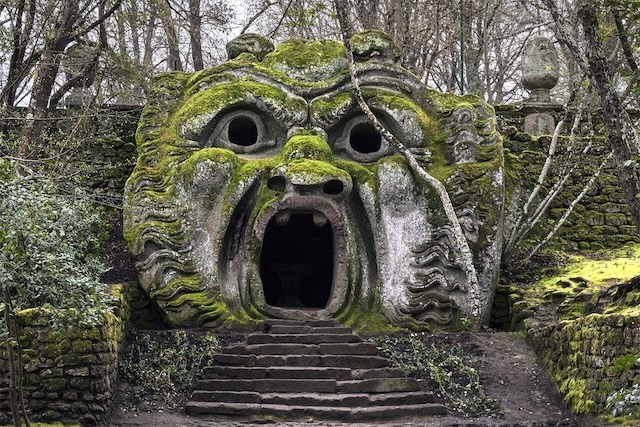 Step into the world of Pan’s Labyrinth: The eerie stone face, with its gaping mouth and moss-covered features, beckons you into a realm where fantasy and danger collide