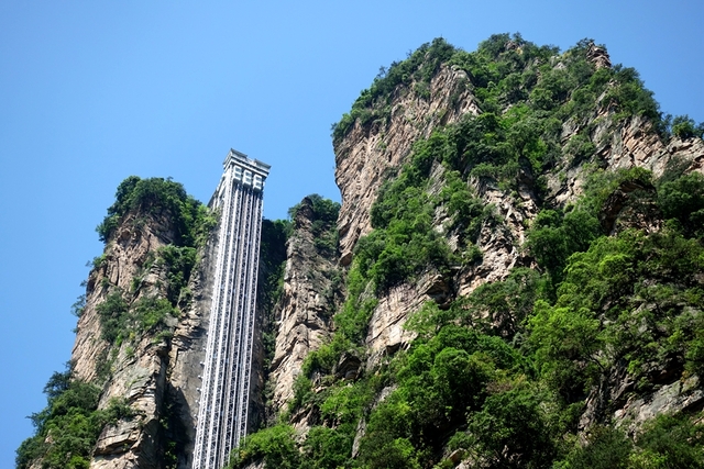 Built into a cliffside, the elevator is divided into two parts: a 156-meter vertical shaft inside the mountain and a 171-meter steel structure outside