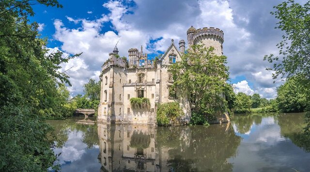 Further south in France, Château de la Mothe-Chandeniers is a castle nearly swallowed by nature