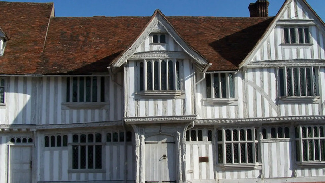 The Lavenham Guildhall in Suffolk, England, is a timber-framed building that showcases the craftsmanship of Medieval carpenters