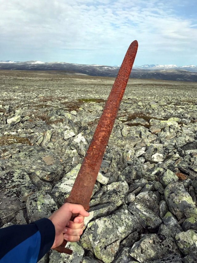 Einar Åmbakk holds the ancient Viking sword, found in the rocky Norwegian mountains