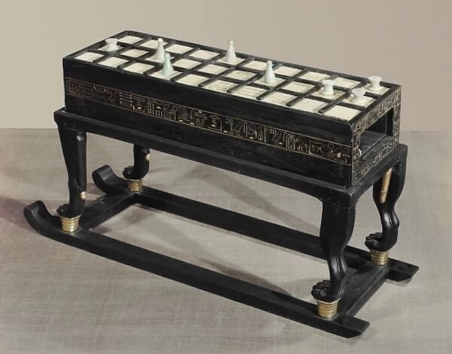 Senet Game Board: A beautifully preserved Senet game board, one of the most ancient and culturally significant games in ancient Egypt, made from ebony and ivory with intricate carvings