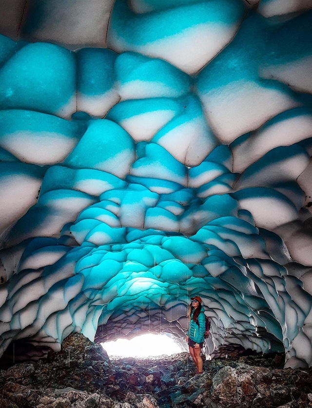 A breathtaking view inside the magical ice caves of Patagonia, with glowing blue ice formations creating a mesmerizing atmosphere