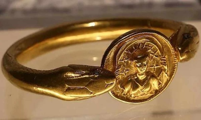 The intricate double-headed snake bracelet made of solid gold, showcasing the wealth of its owner in ancient Pompeii