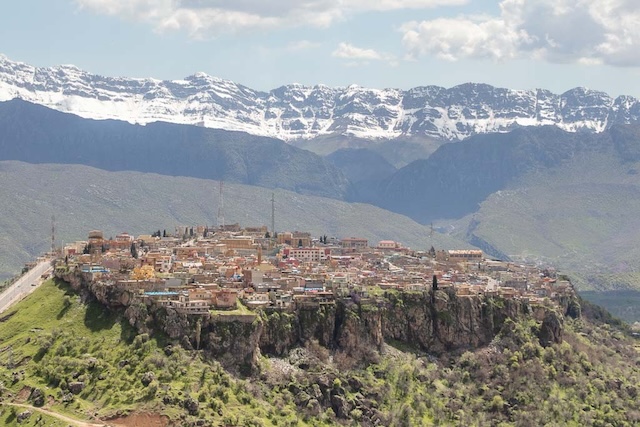 A closer look at Amadiyah, showcasing the city's unique blend of traditional houses and ancient structures amidst a backdrop of snow-capped mountains