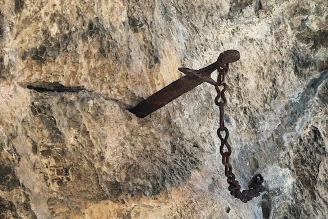 A closer view of the Durandal sword secured by chains in Rocamadour before its sudden disappearance, a relic of France's mythological past