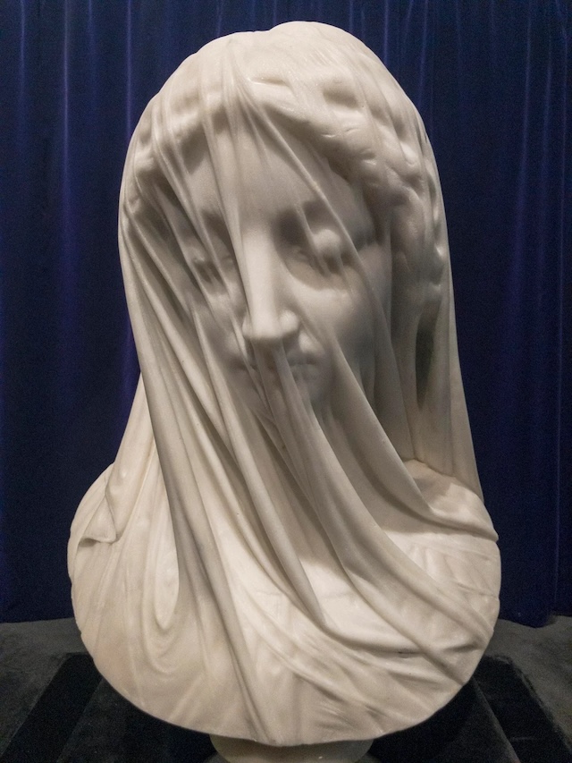 A closer look at the Veiled Virgin shows the exquisite craftsmanship, making the marble appear as transparent fabric