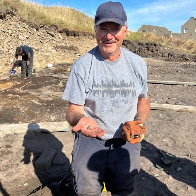 John Ralph proudly shows his remarkable find, a Pictish ring from the Burghead Fort dig, believed to date back over a millennium