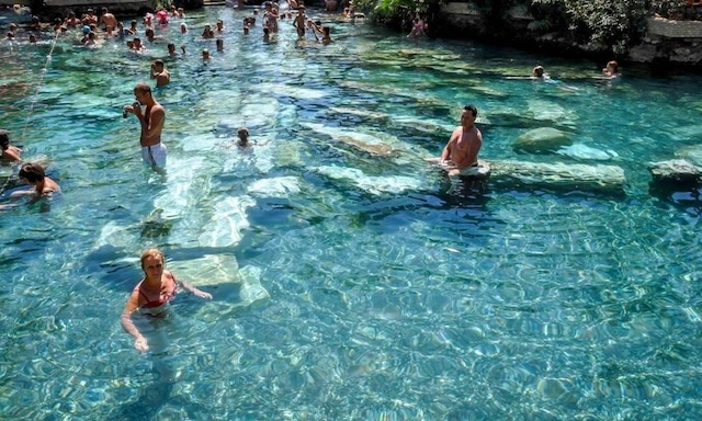 Visitors enjoying a relaxing swim in Cleopatra's Pool, experiencing the same warm, healing waters that once bathed the legendary Egyptian quee