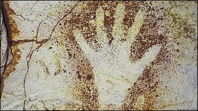 Hand stencils left by ancient artists in the Cosquer Cave, believed to have symbolic or ritualistic significance