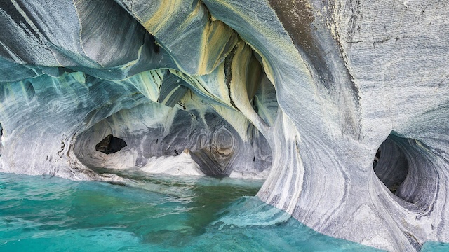 The beautiful marble-like formations of the glacial caves in Patagonia, with swirling patterns that look like nature's masterpiece, sculpted over centuries by ice and water