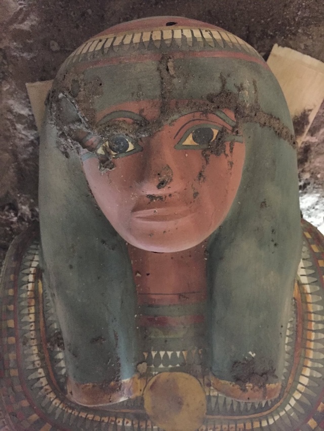 The detailed face mask of the sarcophagus, revealing the serene expression of Amenrenef, an ancient court advisor, as it emerges from its long-hidden resting place