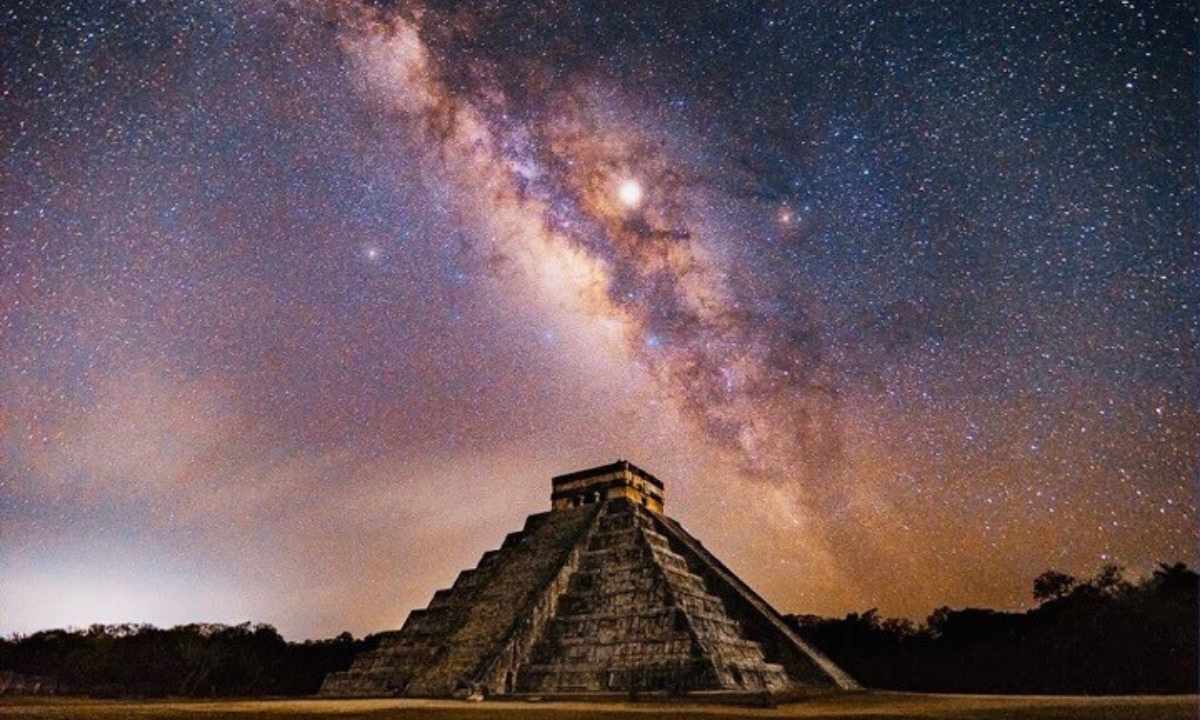 The majestic Temple of Kukulcan at night, under the glow of the Milky Way, highlighting the Maya's deep connection to astronomy