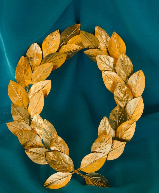 A golden laurel wreath carefully preserved from ancient Greece, symbolizing honor and achievement in athletic and ceremonial contexts