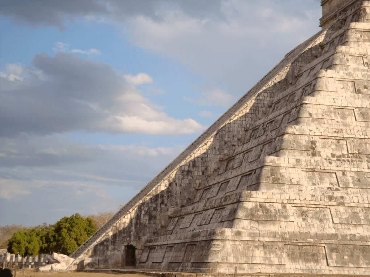 As the sunlight shifts, the shadow of the serpent slowly descends the stairs of the Kukulcan Temple during the equinox, a marvel of Maya architecture