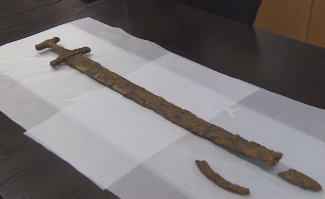 The sword undergoing initial preservation efforts to prevent further corrosion and analyze its historical context