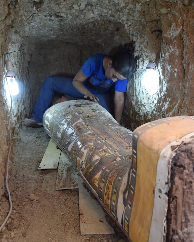 Archaeologists perform the final restoration work on the sarcophagus, preparing it for further study and conservation