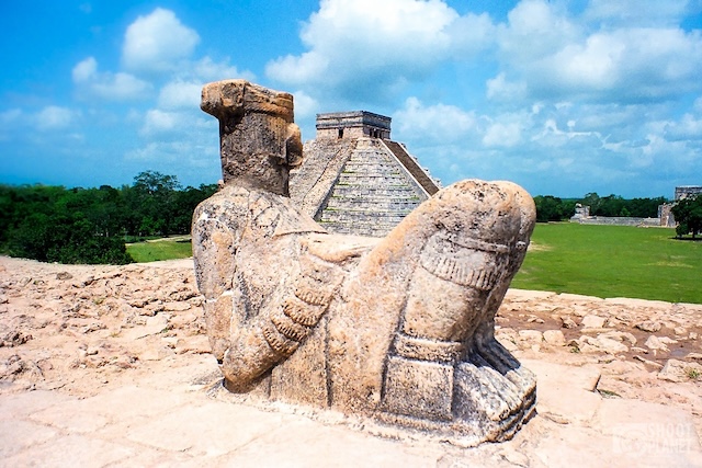 Chac Mool statue overlooking the Kukulcan Temple at Chichen Itza, believed to be a figure representing a messenger to the gods or a sacrificial offering bearer in Maya and Toltec cultures