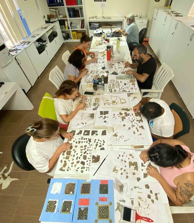 In the lab, specialists meticulously sort and analyze fragments, piecing together historical artifacts