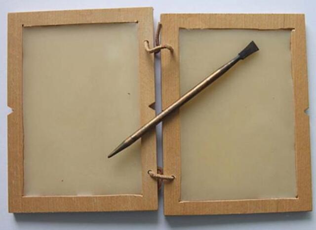 A Roman-era wax tablet and stylus showcase the tools once used for writing and education.