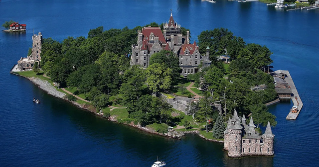 A breathtaking aerial shot of Heart Island, featuring Boldt Castle amidst lush greenery and surrounded by the serene waters of the Thousand Islands.