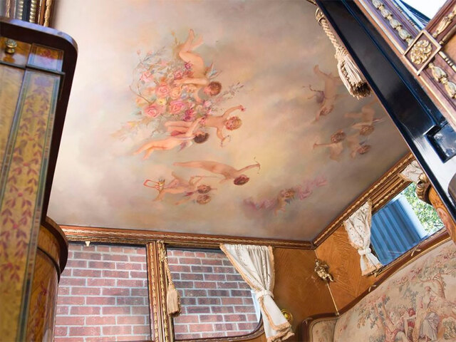 A ceiling mural of cherubs, adding a heavenly charm to the already divine interior of the Rolls Royce.