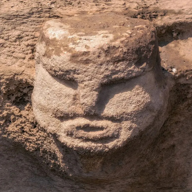 A close-up of a human-like face carved into stone at Karahantepe, showcasing the artistic capabilities and symbolic representations used by Neolithic inhabitants.