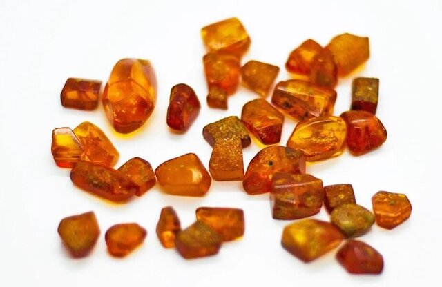 A collection of amber fragments, showcasing the raw material that was highly valued in Mycenaean society.