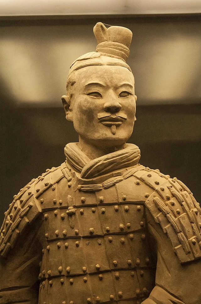 A detailed close-up of a terra-cotta warrior, highlighting the artistry and individuality of each sculpture.