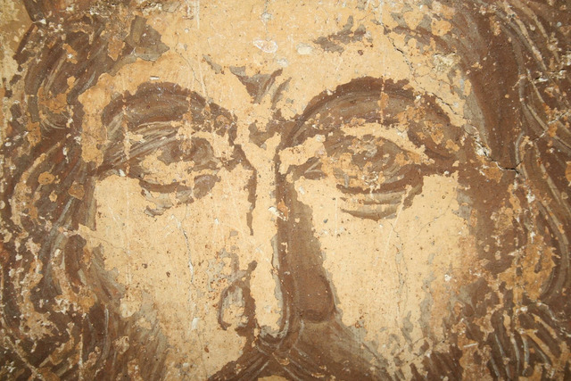 A detailed close-up of the emperor's eyes, capturing the intricate artistry and the emotive depth conveyed by the painter.