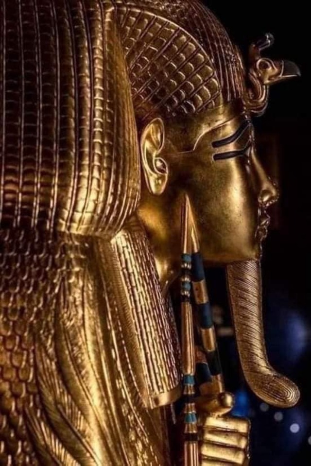 A detailed view of King Tutankhamun's headdress and cobra ornament, symbolizing protection and royal power in ancient Egyptian beliefs.