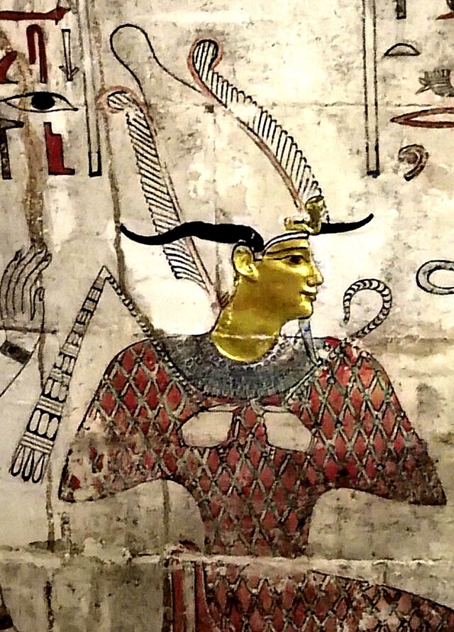 A golden-faced depiction of Osiris, painted in intricate detail, marking the divine significance of the burial site and the deceased's connection to the gods.