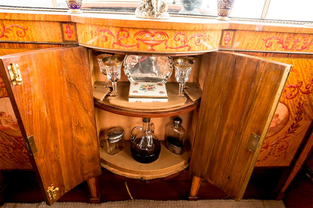 A hidden minibar inside the Rolls Royce, stocked for an unparalleled vintage travel experience.