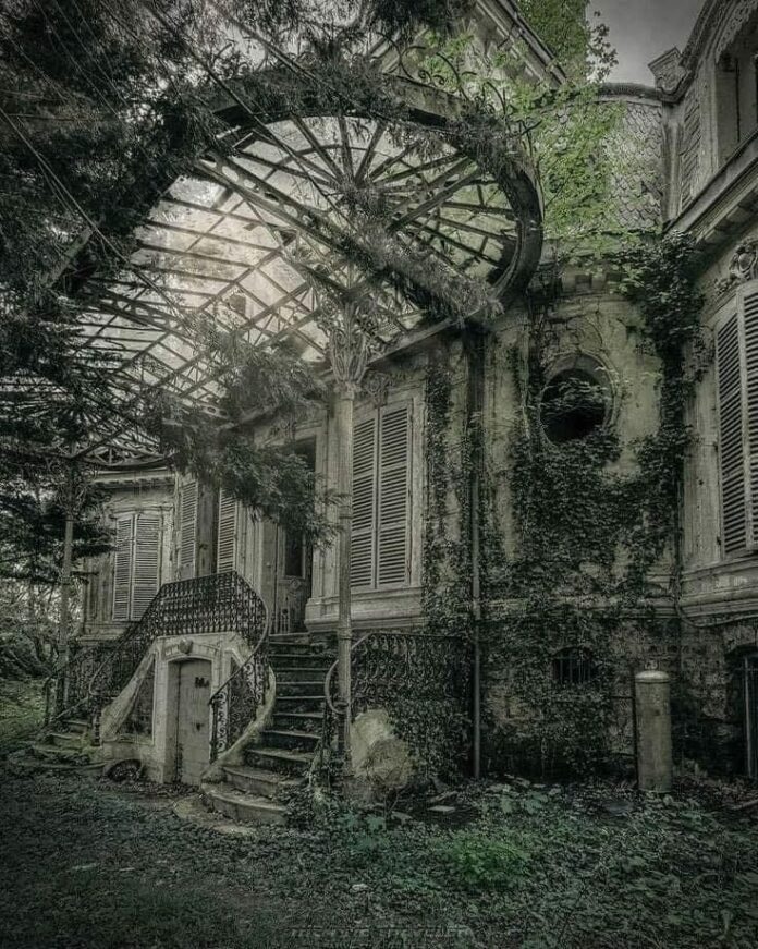 A mesmerizing view of the ivy-clad main entrance of the abandoned Chateau Verdure.