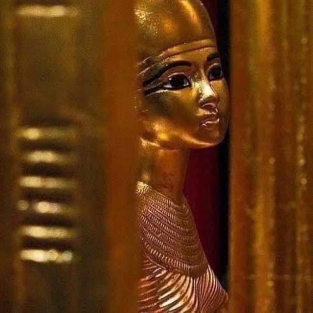 A mysterious and captivating golden statue of an ancient Egyptian figure, partially concealed, reflecting the artistry of the period.