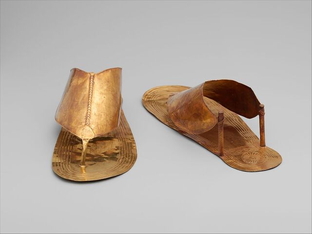 A pair of golden sandals, exquisitely adorned, symbolizes the wealth and status of their ancient owner.