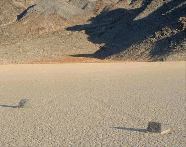 A pair of stones frozen in time on the vast, cracked surface of Racetrack Playa.