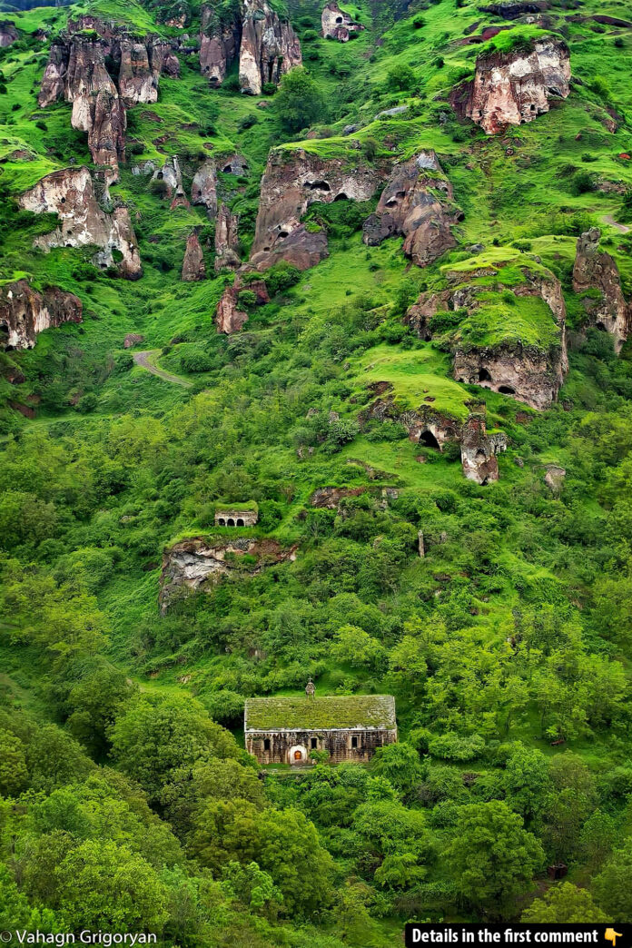 A picturesque view of the lush greenery and ancient cave dwellings of Old Khndzoresk, blending nature and history.