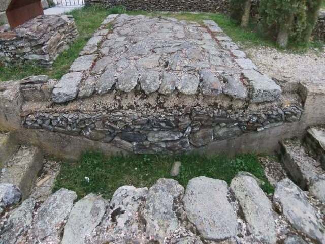 A preserved section of an ancient Roman road showcasing its durable construction and stone-paved surface, still intact after centuries.