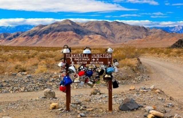 A quirky sight: tea kettles hanging from the iconic Death Valley sign.