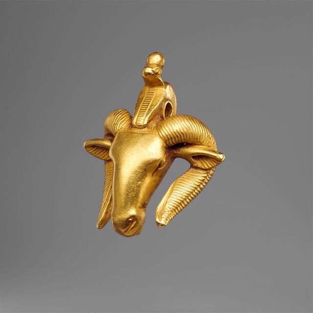 A ram’s head amulet, representing fertility and protection, demonstrates the symbolic power of gold in spiritual practices.