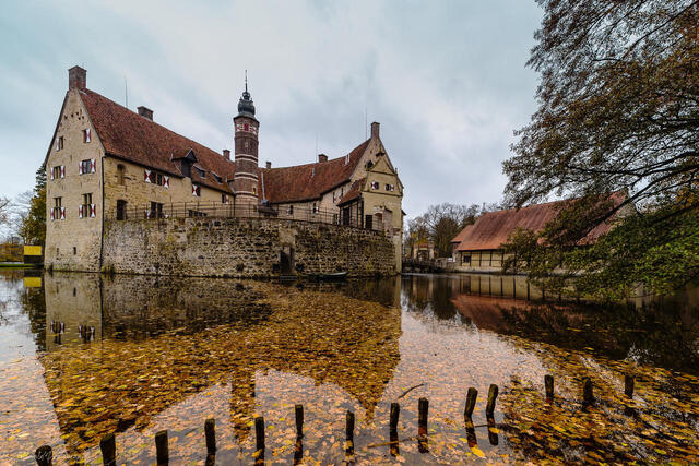 A reflective shot of the castle and its moat on a serene day, capturing the essence of its timeless allure.